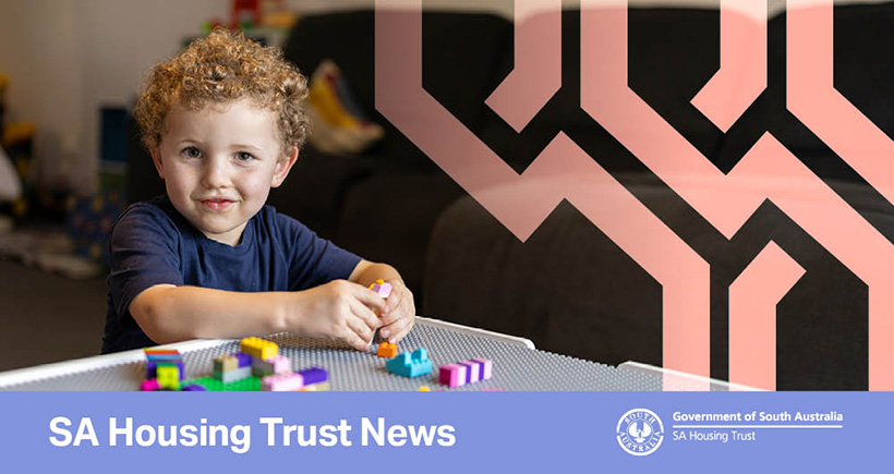 Young boy sitting at a table playing with Lego