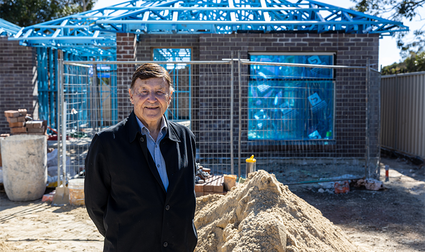 Rob standing in front of a new SA Housing Trust home being built