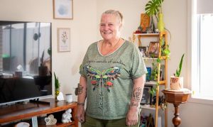 Julie standing in her living room of her new home in Whyalla's new public housing development.