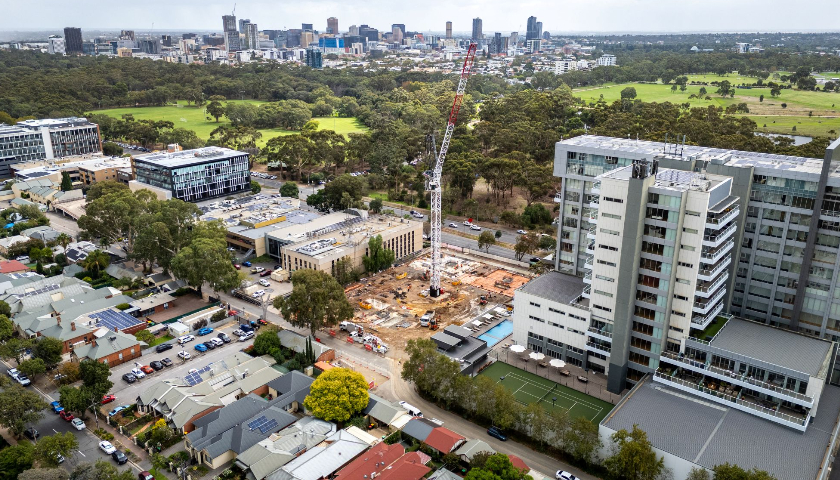 Aerial shot of a construction site with a crane at the centre.