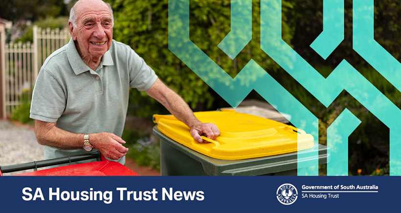 Elderly man standing next to rubbish bins in driveway