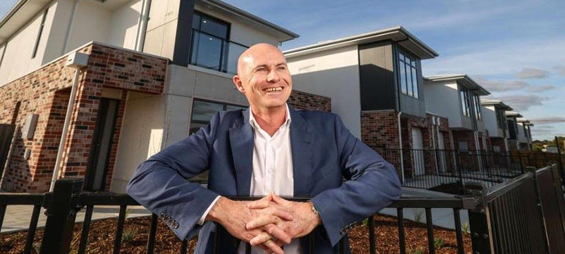 Mark Hayward Executive Director, Property Services in front of new public housing Mark Hayward Executive Director, Property Services in front of new public housing